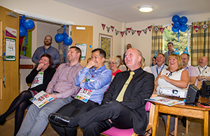 Photograph of colleagues listening to a presentation in celebration of the ten-year anniversary of NHS Informatics Merseyside
